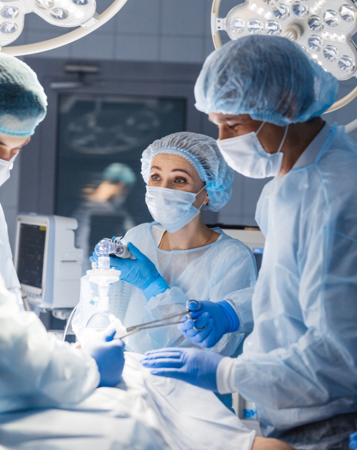 Surgical team in an operating room - supplemental insurance covers private and semi-private hospital care